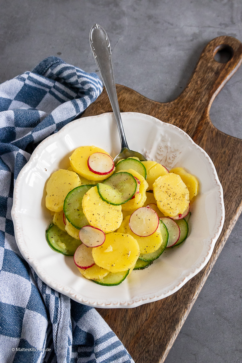 Klassischer Kartoffelsalat mit Gurke und Radieschen.
