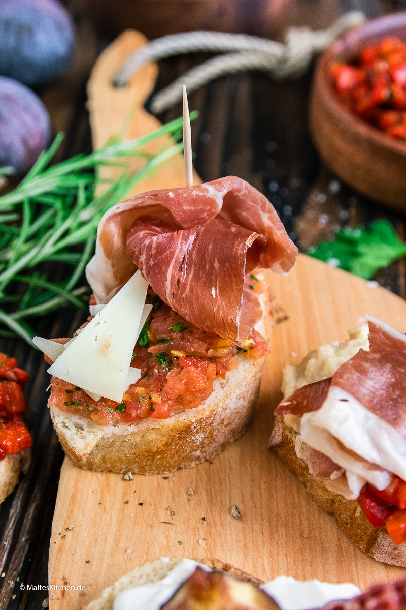Pintxos mit Tomaten, Manchego und ConsorcioSerrano-Schinken.