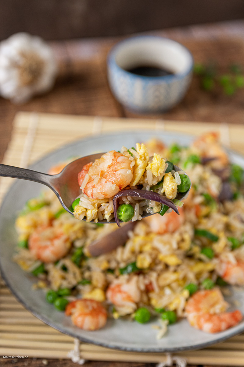 Gebratener Reis mit Garnelen, Gemüse und Ei aus dem Wok.